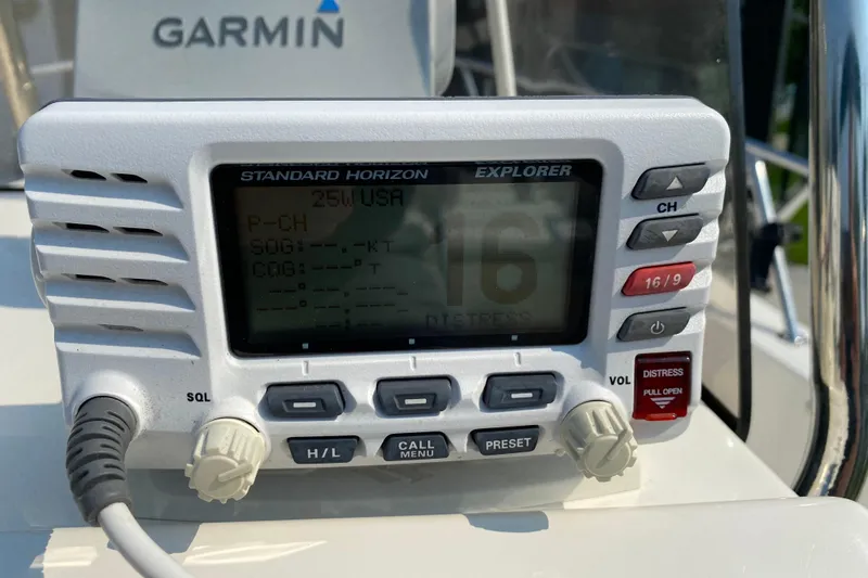 Slide: The Image of VHF radio on 2001 Boston Whaler 18 Dauntless boat, featuring Garmin equipment. - 24