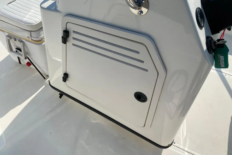 Slide: The Image of 2001 Boston Whaler 18 Dauntless boat console with storage compartment and seat detail. - 26