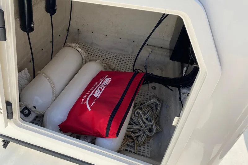 Slide: The Image of Storage compartment of a 2001 Boston Whaler 18 Dauntless with fenders and ropes. - 27