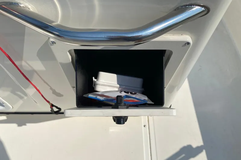 Slide: The Image of Storage compartment on a 2001 Boston Whaler 18 Dauntless boat, containing small items. - 28