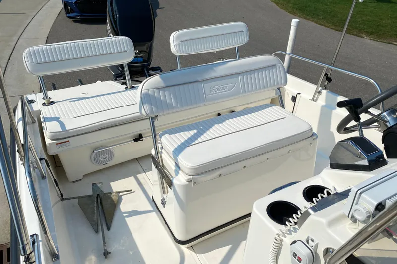 Slide: The Image of 2001 Boston Whaler 18 Dauntless boat interior with white seating and steering console. - 30