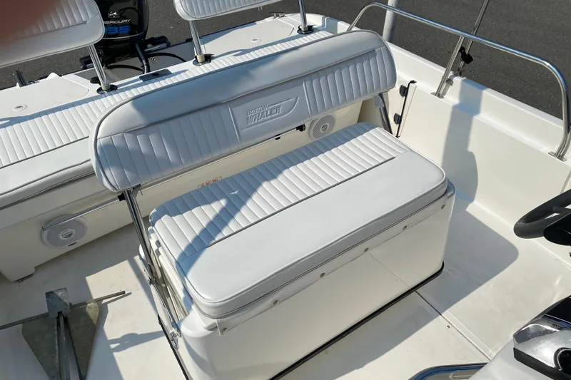 Slide: The Image of 2001 Boston Whaler 18 Dauntless boat interior with white seating and steering console. - 31