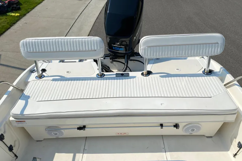 Slide: The Image of 2001 Boston Whaler 18 Dauntless boat with white cushioned seating and Mercury engine. - 34