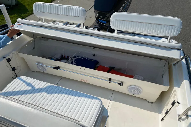 Slide: The Image of 2001 Boston Whaler 18 Dauntless boat with open storage compartment and seating. - 35