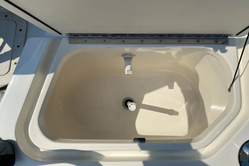 Slide: The Image of Open storage compartment on a 2001 Boston Whaler 18 Dauntless boat. - 36