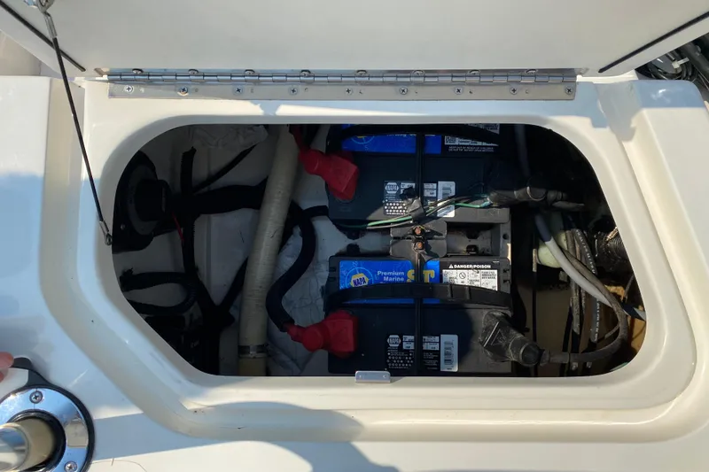 Slide: The Image of Battery compartment of a 2001 Boston Whaler 18 Dauntless boat, showing marine batteries. - 37