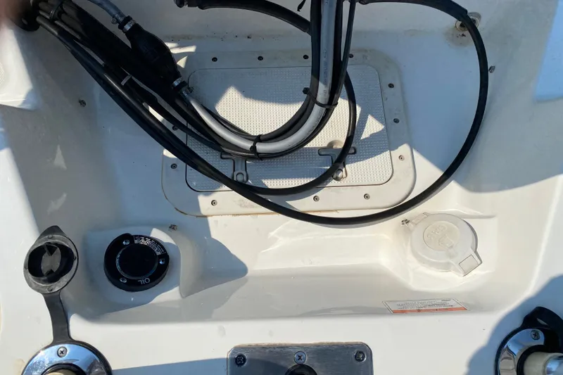 Slide: The Image of 2001 Boston Whaler 18 Dauntless boat interior with cables and oil cap. - 40