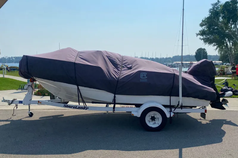 Slide: The Image of Covered 2001 Boston Whaler 18 Dauntless on trailer, parked near marina. - 46