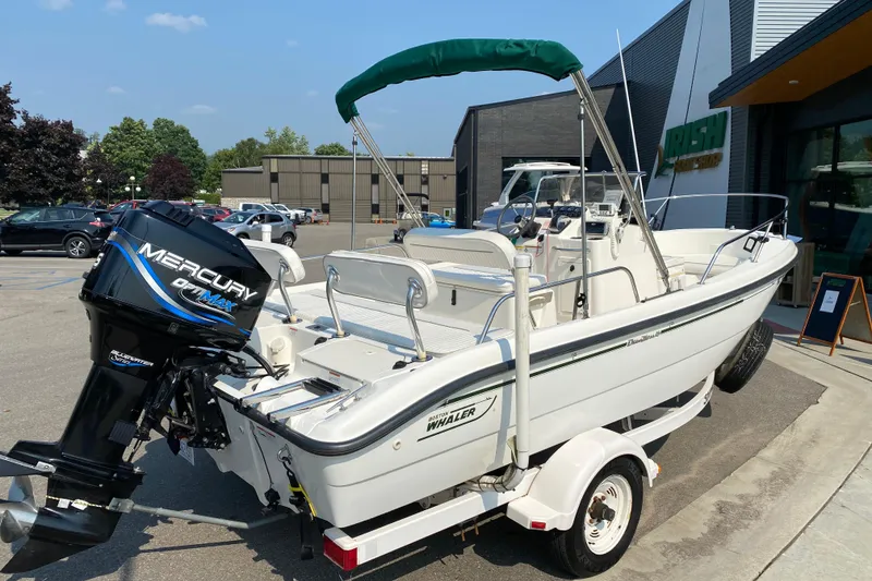 Slide: The Image of 2001 Boston Whaler 18 Dauntless boat with Mercury outboard motor on trailer. - 6