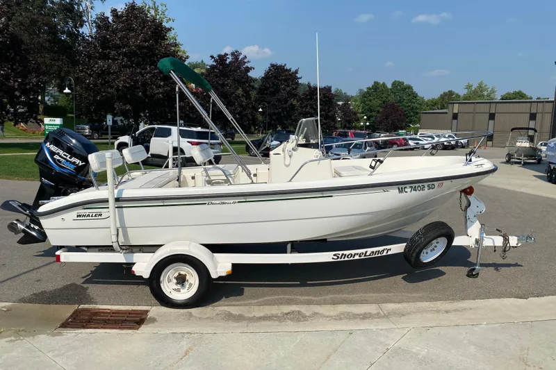 Slide: The Image of 2001 Boston Whaler 18 Dauntless boat on trailer, parked outdoors. - 7
