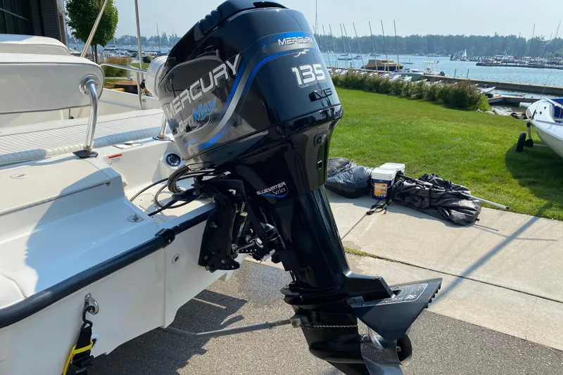 Slide: The Image of 2001 Boston Whaler 18 Dauntless with Mercury 135 outboard motor by the marina. - 8