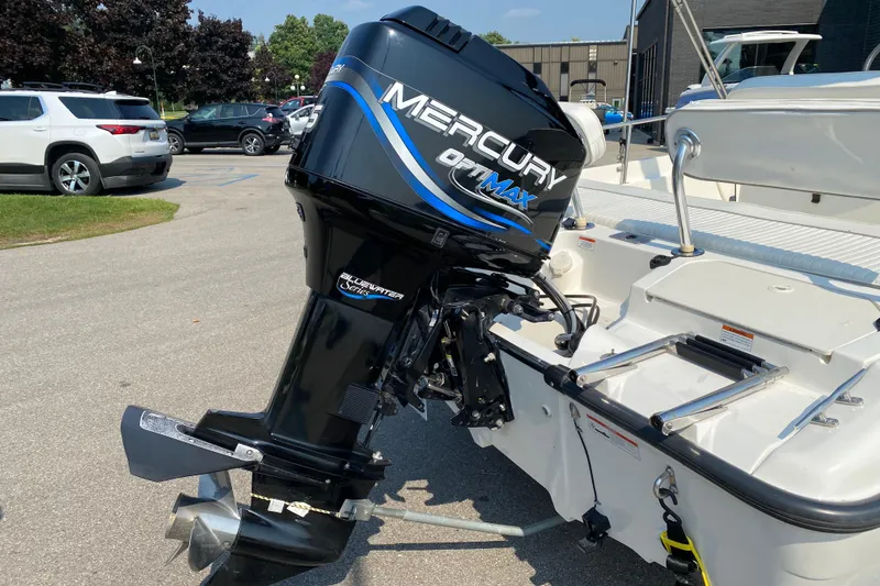 Slide: The Image of 2001 Boston Whaler 18 Dauntless with Mercury OptiMax outboard motor in parking lot. - 9