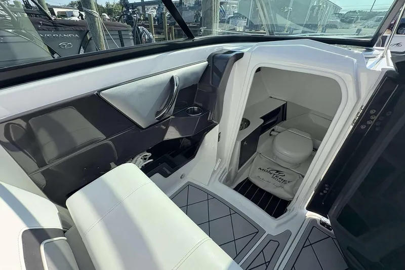 Slide: The Image of Interior of 2017 Monterey 298SS boat featuring a compact bathroom with toilet. - 14
