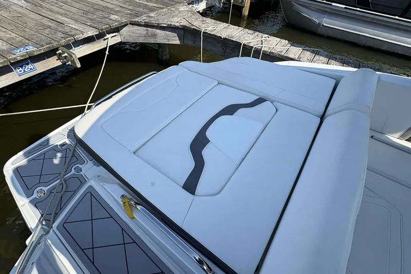 Slide: The Image of 2017 Monterey 298SS boat with white seating, docked at a wooden pier. - 15