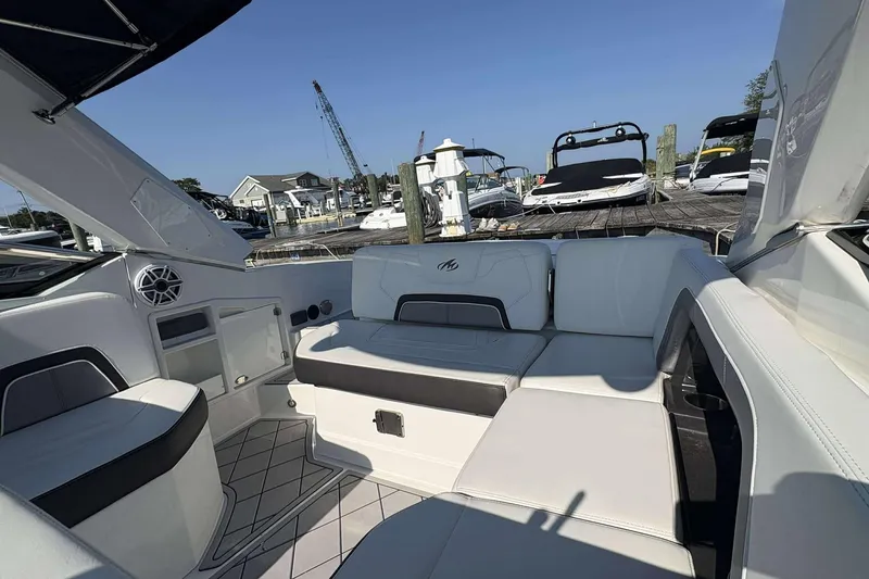 Slide: The Image of 2017 Monterey 298SS boat interior with white seating, docked at marina. - 3