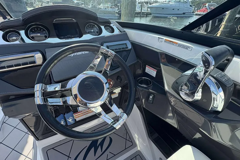 Slide: The Image of 2017 Monterey 298SS boat dashboard with steering wheel and controls, docked at marina. - 4