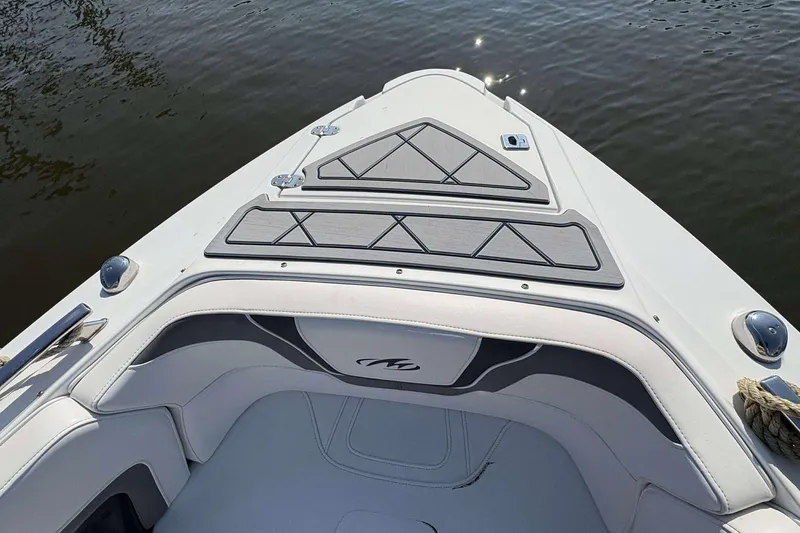 Slide: The Image of 2017 Monterey 298SS boat bow with cushioned seating and sleek design on calm water. - 6