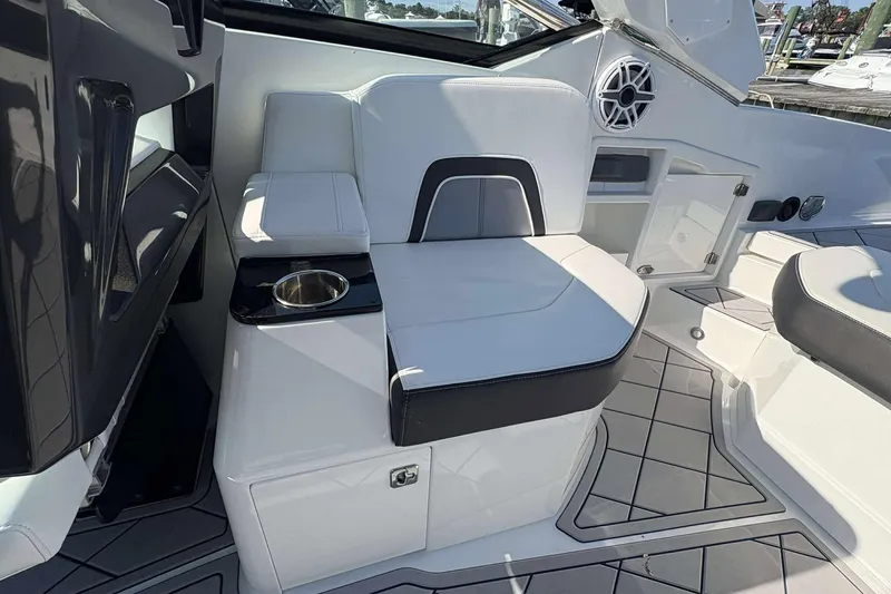 Slide: The Image of 2017 Monterey 298SS boat interior with white seating and cup holder. - 7