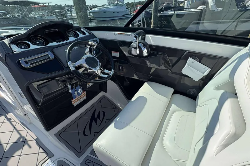 Slide: The Image of 2017 Monterey 298SS boat interior with steering wheel and white seating. - 9