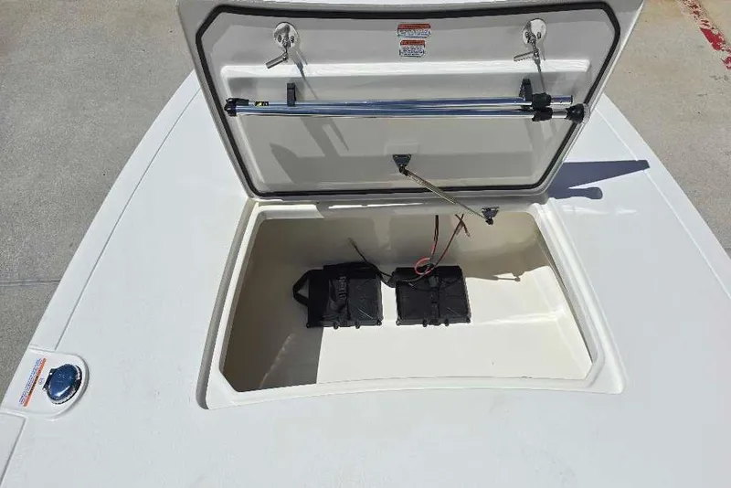 Slide: The Image of Open storage compartment of 2026 Mako 18 Pro Skiff boat, showing interior details. - 59
