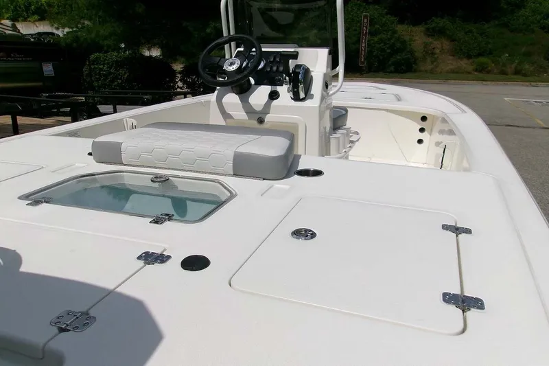 Slide: The Image of 2026 Mako 18 Pro Skiff boat interior with steering console and seating. - 5
