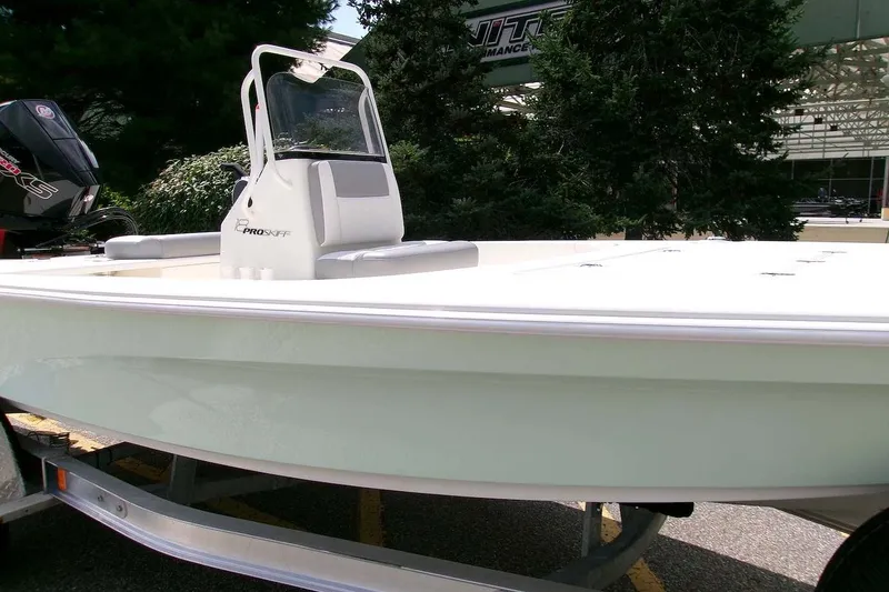 Slide: The Image of 2026 Mako 18 Pro Skiff boat on trailer, outdoor setting. - 1