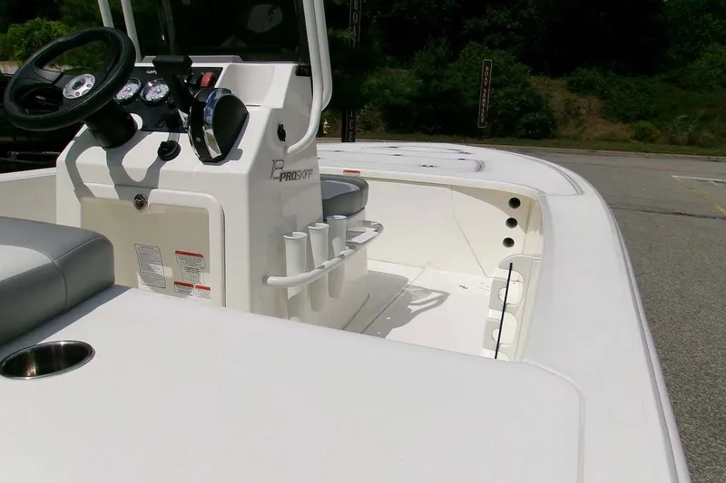 Slide: The Image of 2026 Mako 18 Pro Skiff boat interior with steering console and seating. - 3