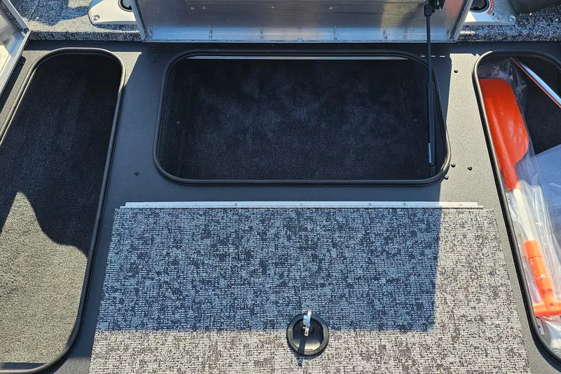 Slide: The Image of 2026 Tracker Pro Team 175 Crappie Edition boat storage compartments with carpeted interior. - 7