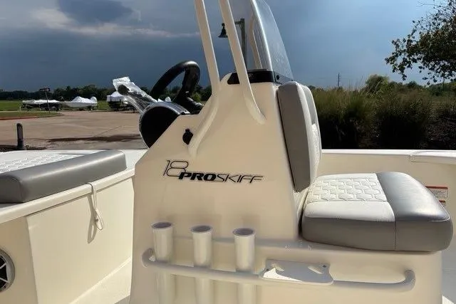 Slide: The Image of 2026 Mako 18 Pro Skiff boat interior with seating and steering console. - 5