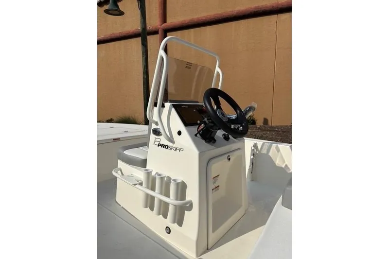 Slide: The Image of 2026 Mako 18 Pro Skiff boat console with steering wheel and rod holders. - 6