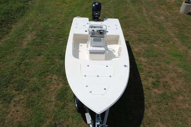 Slide: The Image of 2026 Mako 18 Pro Skiff boat on grass, aerial view. - 6