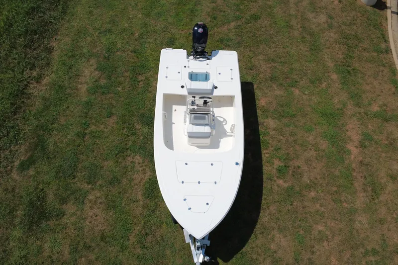 Slide: The Image of 2026 Mako 18 Pro Skiff boat on grass, aerial view. - 7