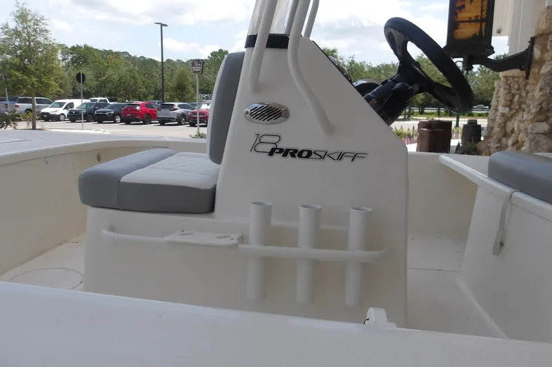 Slide: The Image of 2026 Mako 18 Pro Skiff boat interior with steering wheel and seating. - 14