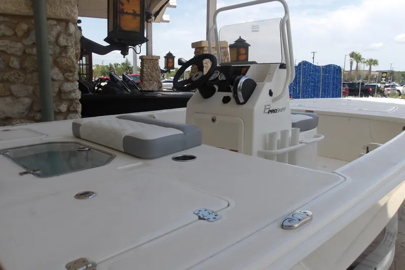 Slide: The Image of 2026 Mako 18 Pro Skiff boat interior with steering console and seating. - 6
