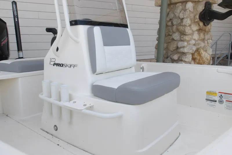 Slide: The Image of 2026 Mako 18 Pro Skiff boat interior with gray and white seating. - 5