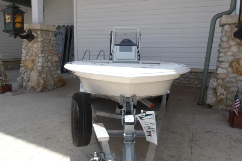 The Image of 2026 Mako 18 Pro Skiff boat on trailer, parked near stone pillars. - 1