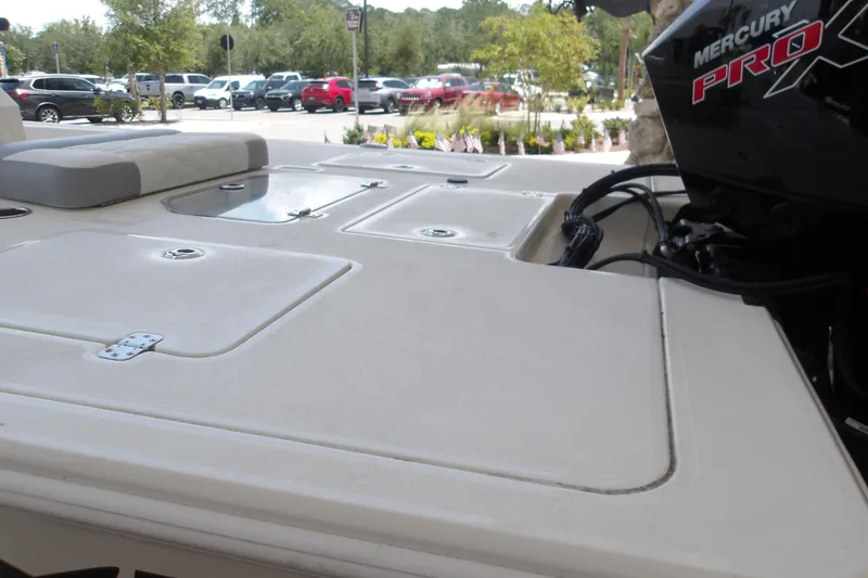 Slide: The Image of 2026 Mako 18 Pro Skiff boat deck with Mercury Pro X engine in parking lot. - 11