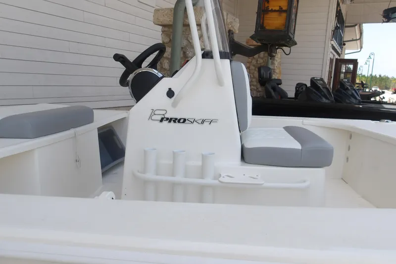 Slide: The Image of 2026 Mako 18 Pro Skiff boat interior with steering console and seating. - 4