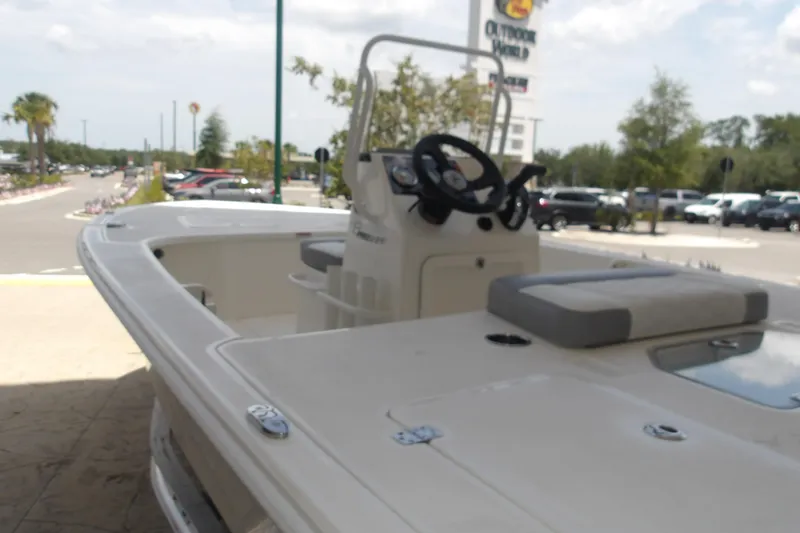 Slide: The Image of 2026 Mako 18 Pro Skiff boat displayed outdoors near a parking lot. - 10