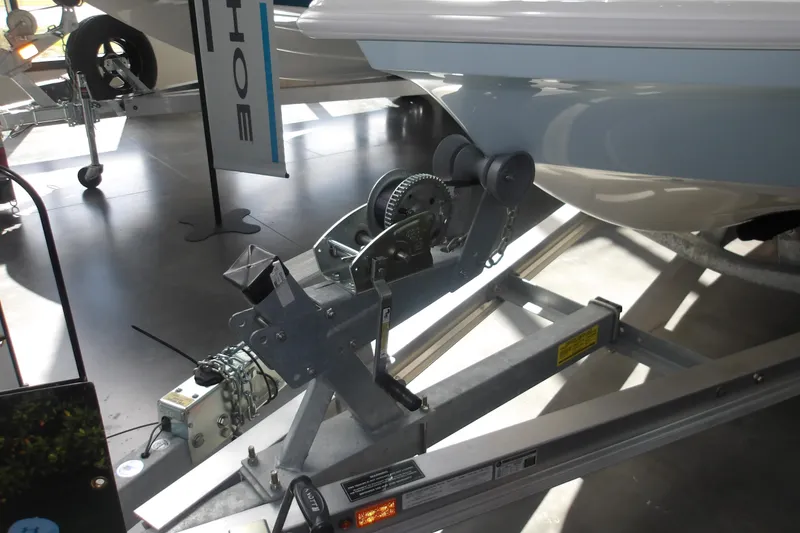 Slide: The Image of 2026 Mako 18 Pro Skiff boat on trailer, showcasing winch and hull details. - 18
