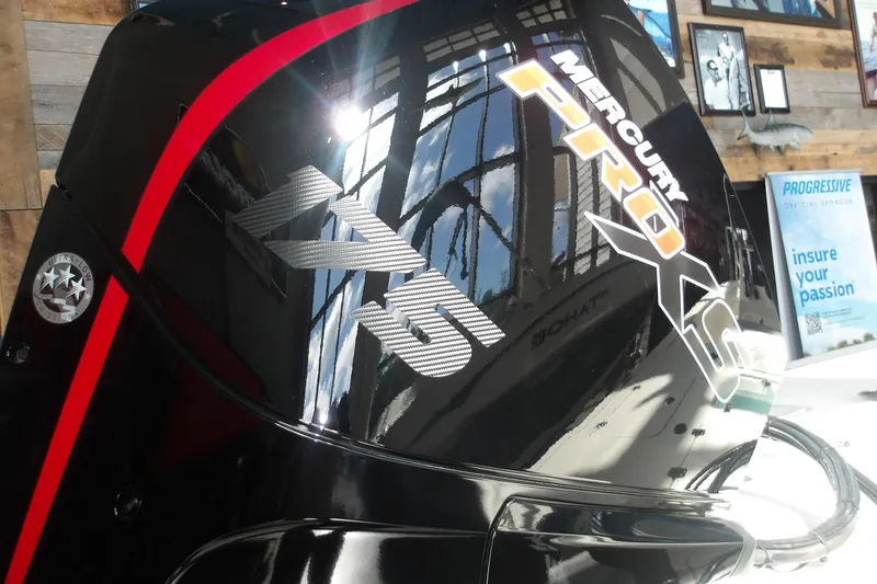 Slide: The Image of Mercury Pro XS engine on 2026 Mako 18 Pro Skiff, displayed indoors with reflective surface. - 8