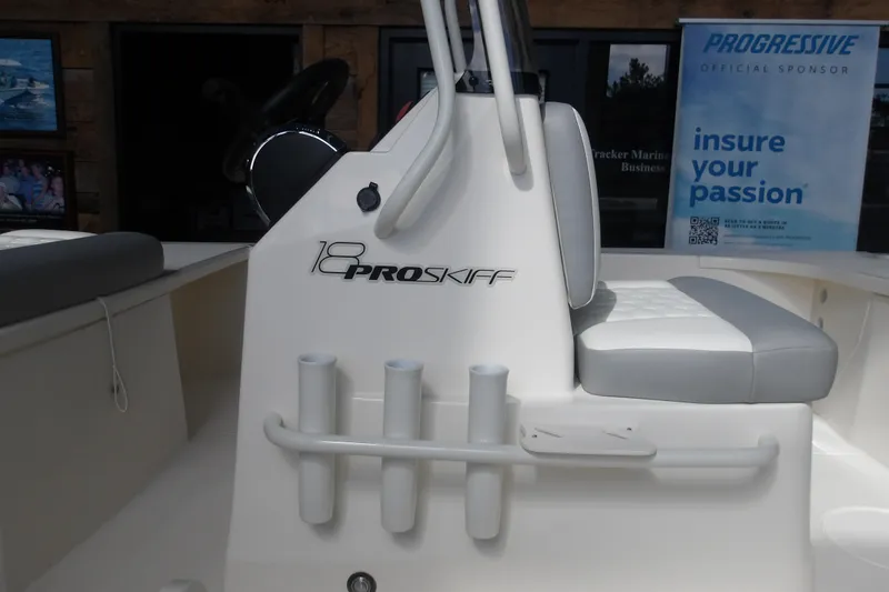 Slide: The Image of 2026 Mako 18 Pro Skiff boat interior with seating and rod holders. - 4