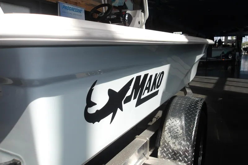 Slide: The Image of 2026 Mako 18 Pro Skiff boat on trailer, showcasing sleek design and logo. - 6