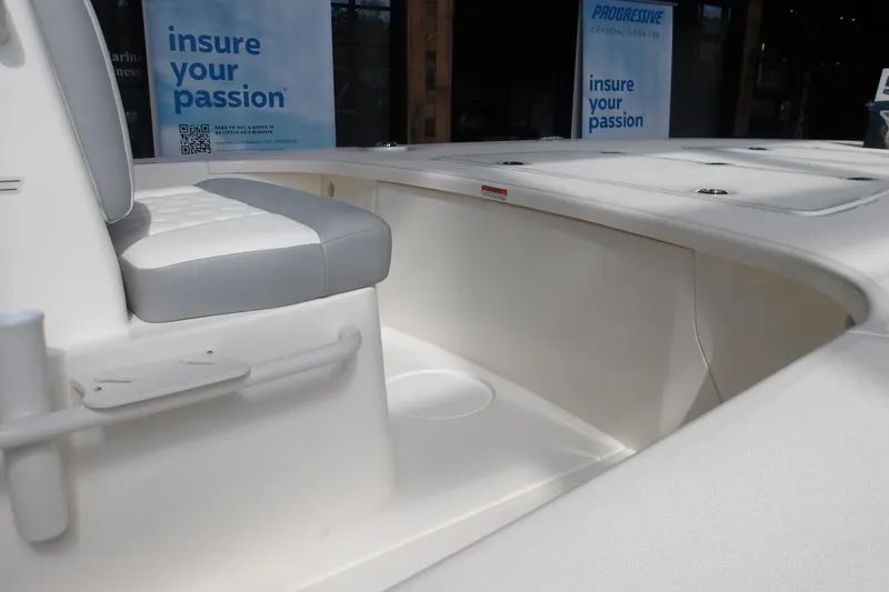 Slide: The Image of 2026 Mako 18 Pro Skiff interior with cushioned seating and storage compartments. - 5