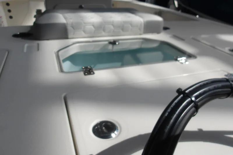 Slide: The Image of 2026 Mako 18 Pro Skiff boat interior with seating and storage compartment. - 10