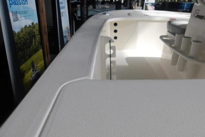 Slide: The Image of 2026 Mako 18 Pro Skiff boat interior with rod holders and textured deck. - 12