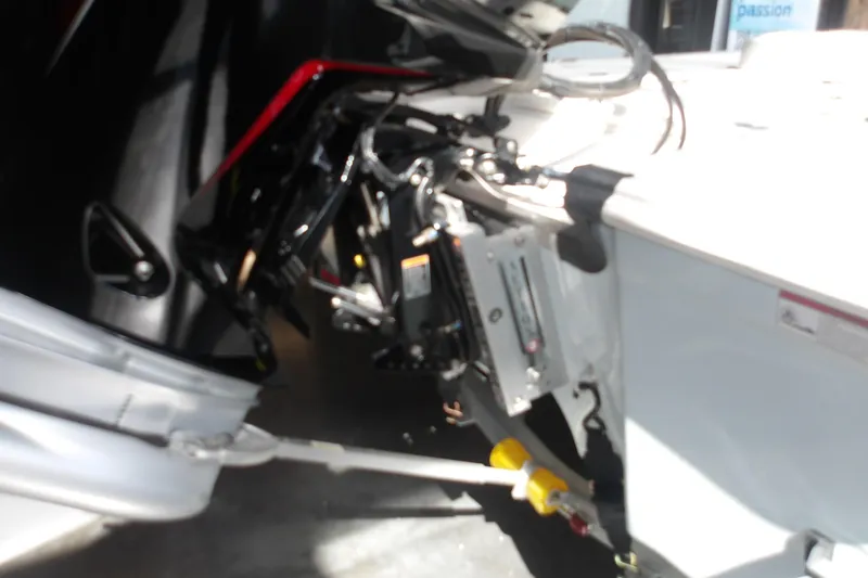 Slide: The Image of 2026 Mako 18 Pro Skiff boat engine and transom detail in a showroom. - 7