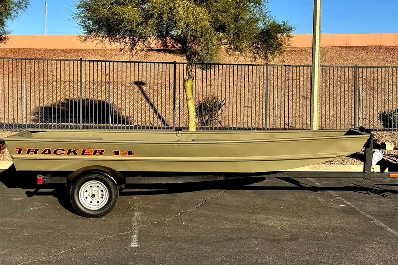 The Image of 2026 Tracker Grizzly 14 Jon boat on trailer, parked outdoors. - 0
