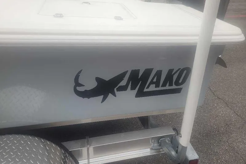 Slide: The Image of 2026 Mako 18 Pro Skiff boat logo on trailer, featuring shark silhouette. - 10