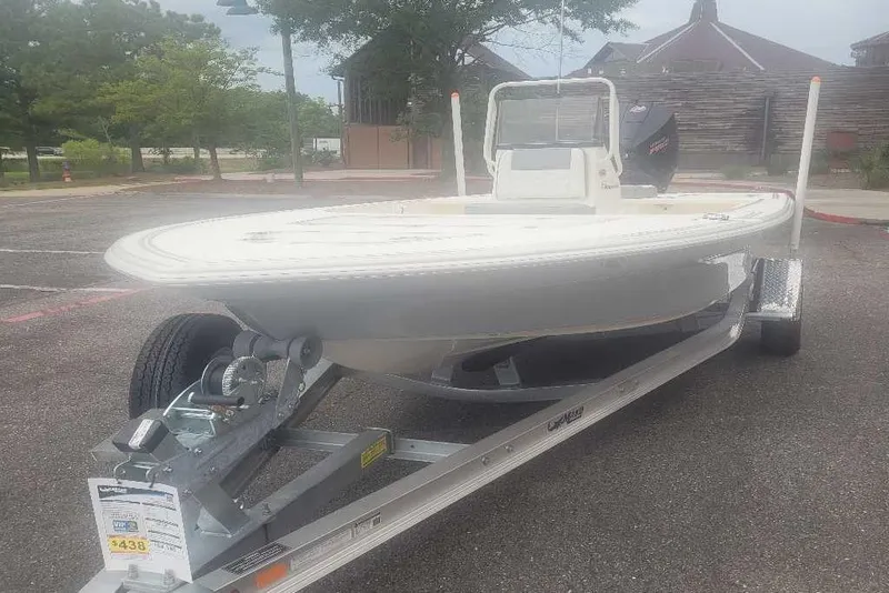 Slide: The Image of 2026 Mako 18 Pro Skiff boat on trailer in parking lot. - 4